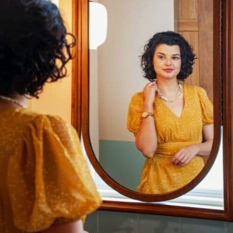 Woman in yellow dress in mirror