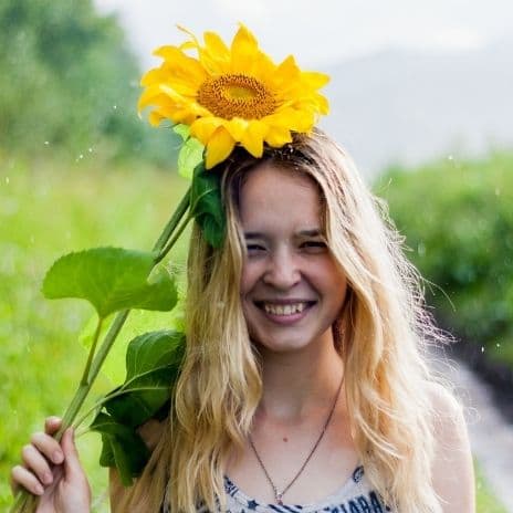 Girl with sunflower above head