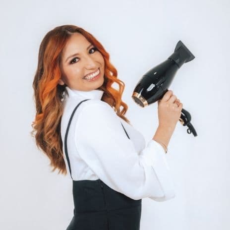 red hair woman with blow dryer