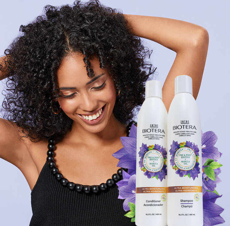 woman smiling next to biotera shampoo bottles