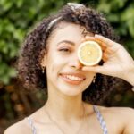 Girl with lemon infront of eye
