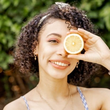 Girl with lemon infront of eye