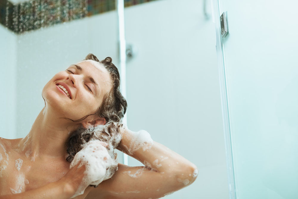 happy woman washing hair