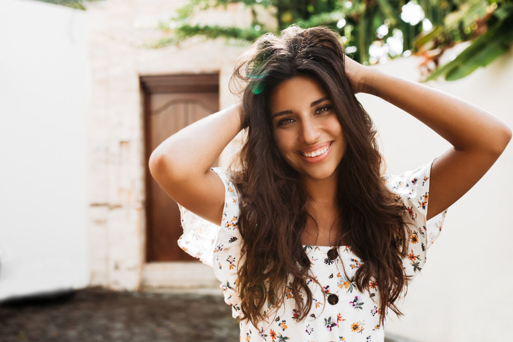 portrait holding long curly hair