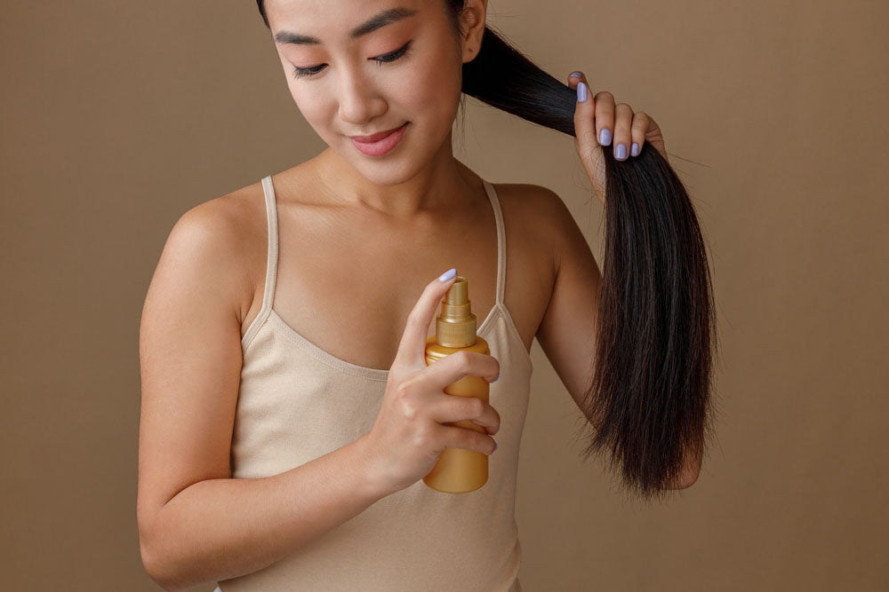 woman applying hair spray