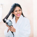 woman bathroom drying hair