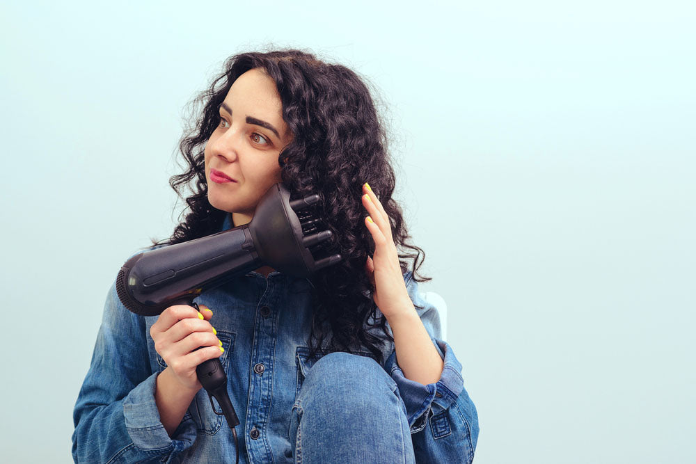 woman using modern hairdryer